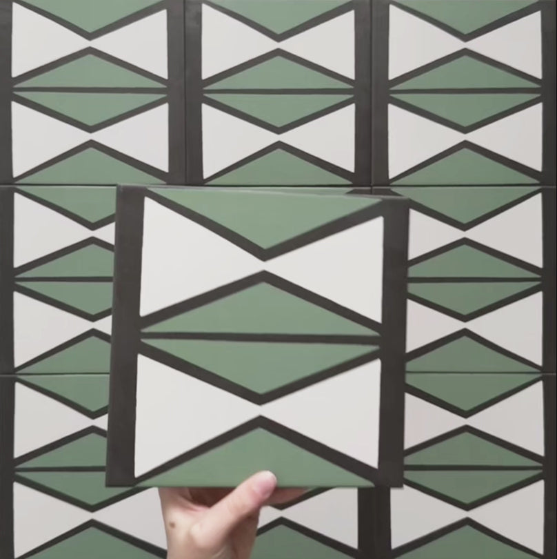 Video showcasing the Geometry Hourglass 20x20cm patterned tile, highlighting its alternating green and cream hourglass design with bold charcoal outlines, and demonstrating how the pattern repeats when multiple tiles are laid together.