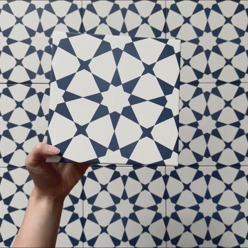 Video showcasing Agraba Navy 20x20cm Moroccan-style ceramic tiles, highlighting their bold navy blue and white geometric star pattern with a smooth matt finish under natural light.