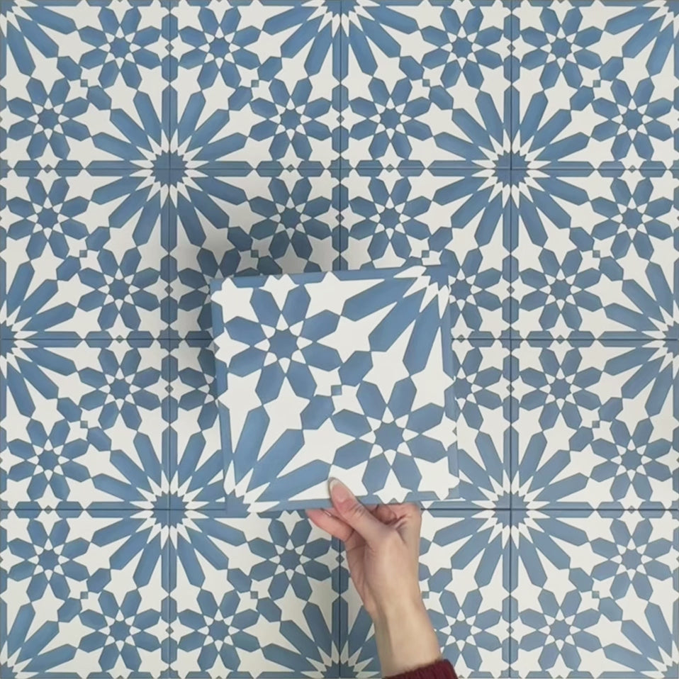Video showcasing Fizaan Azure Blue 20x20cm Moroccan-style porcelain tiles, highlighting the repeating geometric pattern and vibrant blue and white tones in close-up detail.
