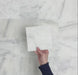 Video showcasing Fitzrovia White 15.2x15.2cm tumbled natural marble tiles arranged in a square layout, showcasing soft white tones, subtle grey veining, tonal variation, and an aged, lightly textured finish.