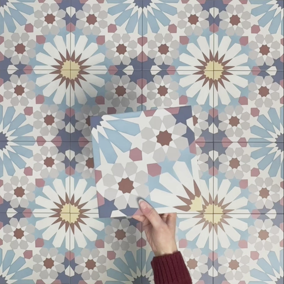 Video showcasing Fizaan Fiera 20x20cm Moroccan-style porcelain tiles, highlighting the repeating geometric pattern and soft blue, red and neutral tones in close-up detail.