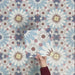 Video showcasing Fizaan Fiera 20x20cm Moroccan-style porcelain tiles, highlighting the repeating geometric pattern and soft blue, red and neutral tones in close-up detail.