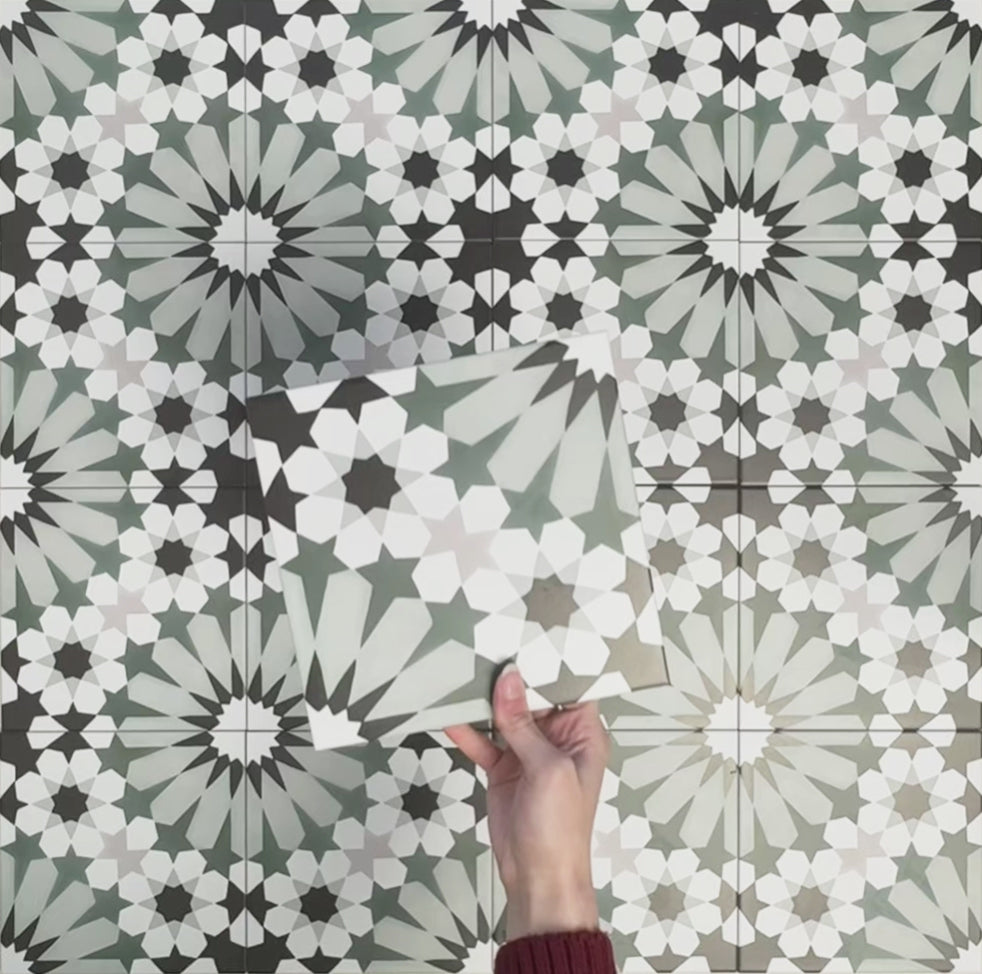 Video showcasing Fizaan Orchid Green 20x20cm Moroccan-style porcelain tiles, highlighting the repeating geometric pattern and green, black and soft neutral tones in close-up detail.