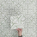Video showcasing Europa Trondheim Sage Green 20x20cm Victorian Moroccan style tiles arranged together to showcase the repeating decorative pattern in sage green and white tones, displayed against a textured green background.