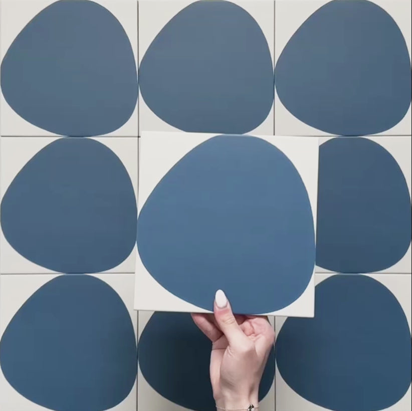 Pebble Beach Reversed Blue 20x20cm patterned tiles featuring a bold deep blue organic circular design, ideal for creating playful statement walls and contemporary patterned floors with a modern geometric feel.