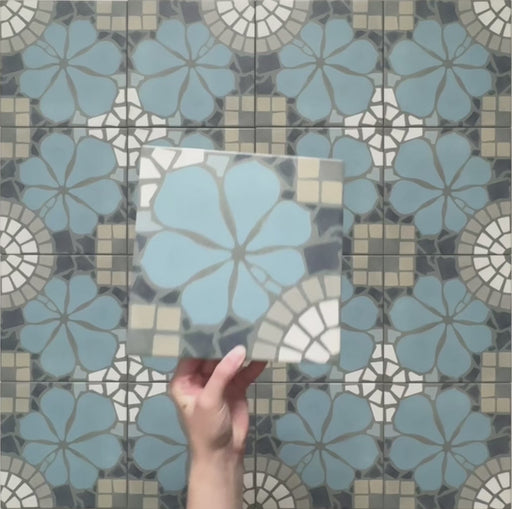 Video showcasing Bloom Azul Blue 20x20cm Moroccan-style ceramic tiles with intricate floral patterns in blue, grey, beige, and white tones, highlighting the detailed design and matte finish in a close-up view.