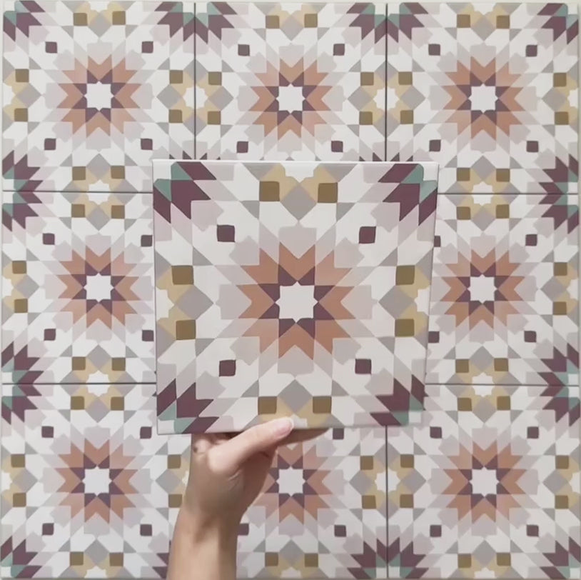 Video showcasing Cabana Manzanillo Moroccan Style 20x20cm porcelain tile featuring a geometric starburst pattern in blush pink, mustard, terracotta, lilac, and turquoise tones, highlighting its matt finish and intricate repeating design.