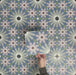 Video showcasing Fizaan Artisan Moroccan-style 20×20cm porcelain tiles, highlighting the blue, green and soft pink geometric floral pattern and surface detail.