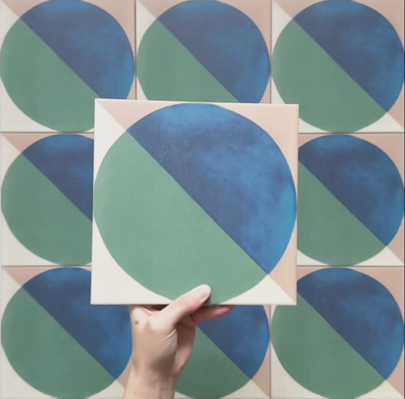 Video showcasing the Geometry Ocean 20x20cm geometric patterned tile, highlighting its blue and green semicircle design, sand and white corner details, and how the pattern connects when multiple tiles are laid together.