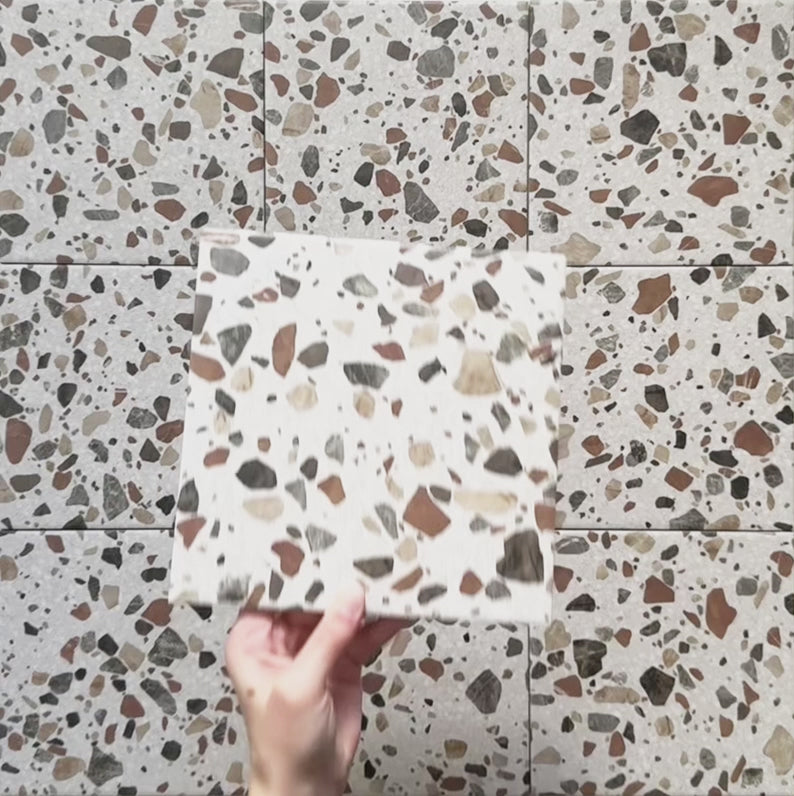 Video showcasing Dino Terrazzo Blanco Drops 20x20cm terrazzo-style ceramic tiles, highlighting the surface texture, large stone-effect chips, and natural matte finish under shifting light.