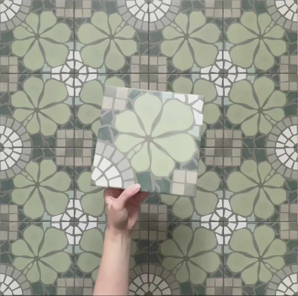 Video showcasing Bloom Green 20x20cm Moroccan-style ceramic tiles with a decorative floral pattern in green, grey, and white tones, highlighting the intricate design and matte finish in a close-up view.