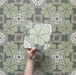 Video showcasing Bloom Green 20x20cm Moroccan-style ceramic tiles with a decorative floral pattern in green, grey, and white tones, highlighting the intricate design and matte finish in a close-up view.