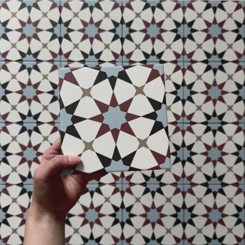 Video showcasing Agraba Mini Atlas 15x15cm Moroccan-style ceramic tiles, highlighting their multicoloured geometric star pattern in blue, terracotta, and white with a smooth matt finish under natural light.