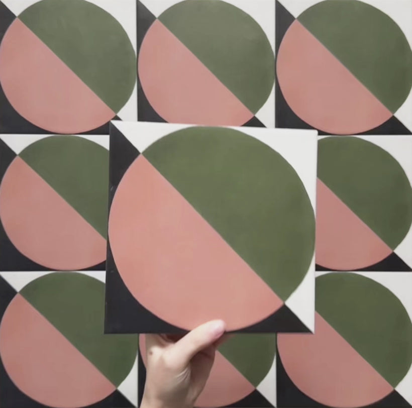 Video showcasing the Geometry Moon 20x20cm geometric patterned tile, highlighting its green and terracotta semicircle design with black and cream corner accents, and demonstrating how the pattern repeats when multiple tiles are laid together.