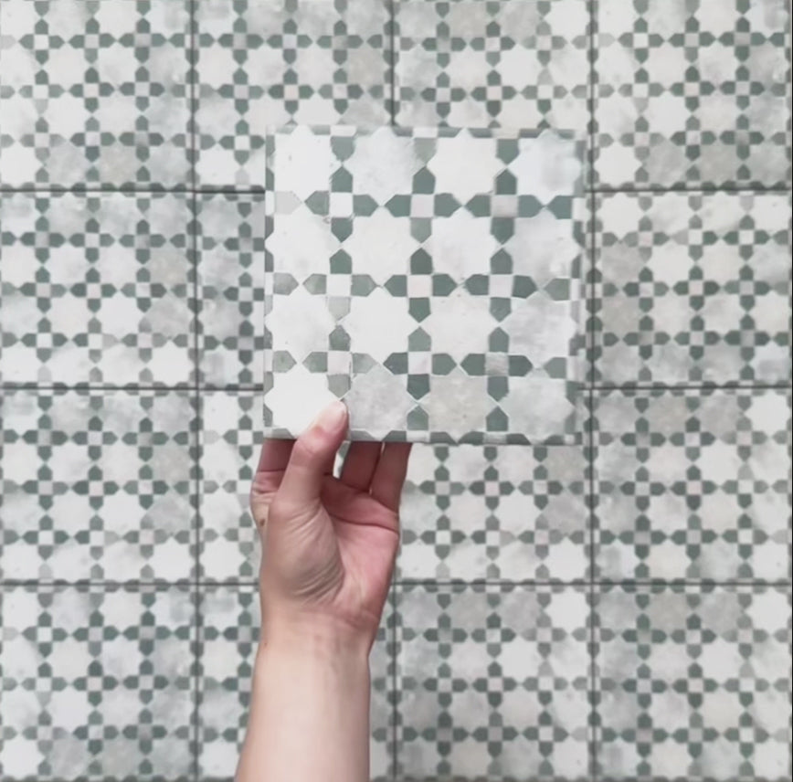 Video showcasing Bedouin Mequinez Green Moroccan-style 15x15cm tiles, highlighting their geometric star and cross pattern in green, grey, and white with a handcrafted, aged effect and subtle surface texture.