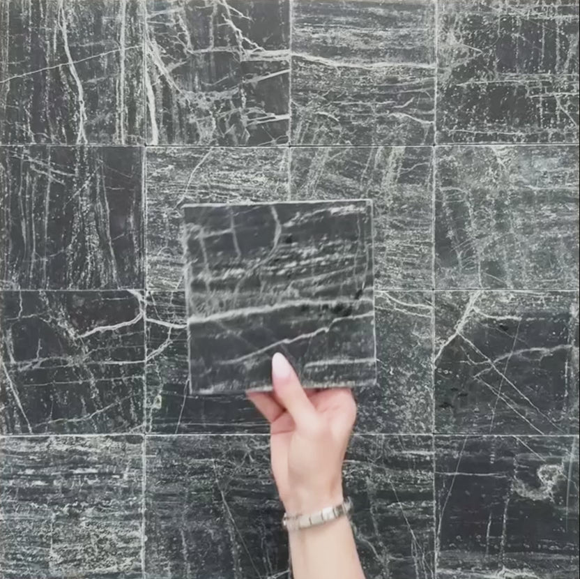 Video of Fitzrovia Verde tumbled natural marble tile in a 15.2cm x 15.2cm square format, featuring deep forest green tones with natural white veining, textured tumbled edges and an authentic aged stone finish.