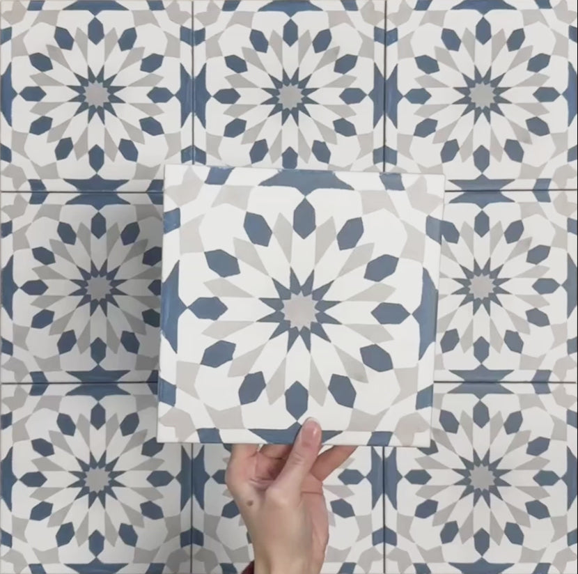 Video showcasing Soukaina Blue A Moroccan-style 20cm x 20cm patterned porcelain tiles, highlighting the blue and white geometric star design, matt finish, and seamless pattern flow when laid together.