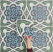 Video showcasing Europa Bucharest 20x20cm Victorian Moroccan style tiles arranged together to showcase the repeating ornamental pattern in blue, green, grey and white tones, displayed against a textured blue background.