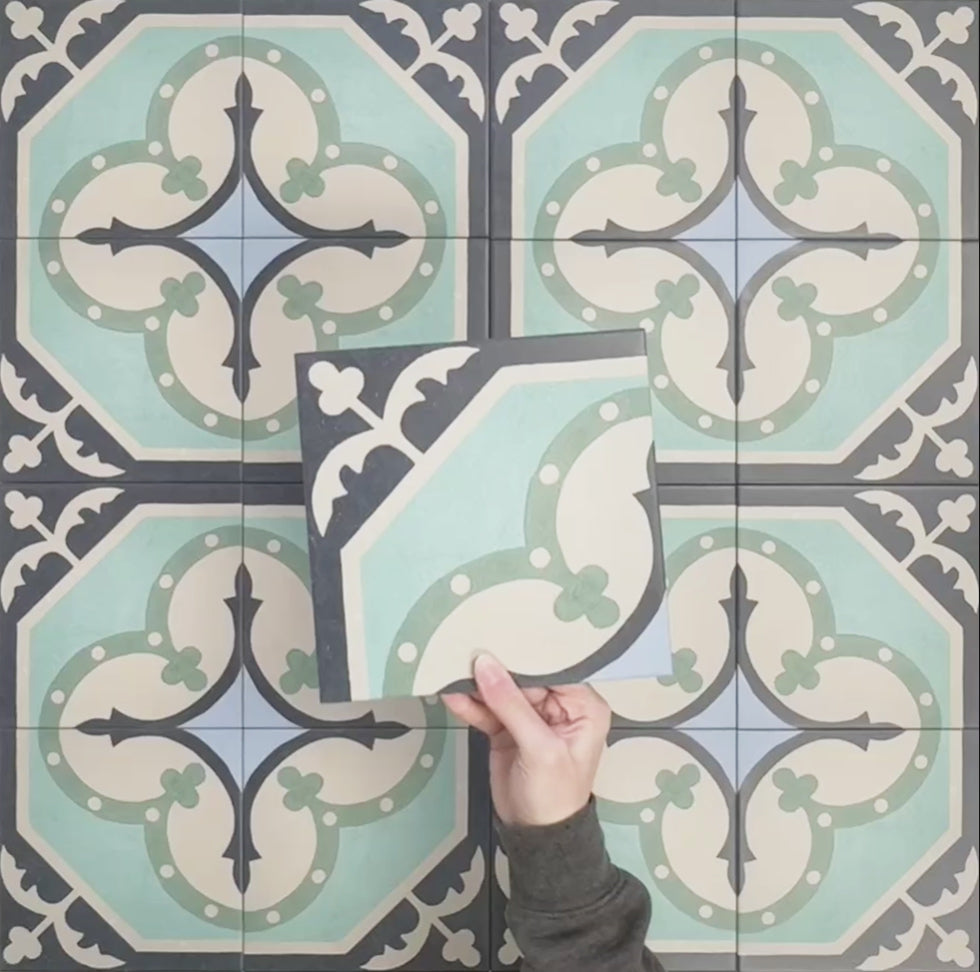 Video showcasing Europa Gothenberg 20x20cm Victorian Moroccan style tiles arranged together to showcase the repeating geometric pattern in blue, mint green and cream tones, displayed against a textured blue background.