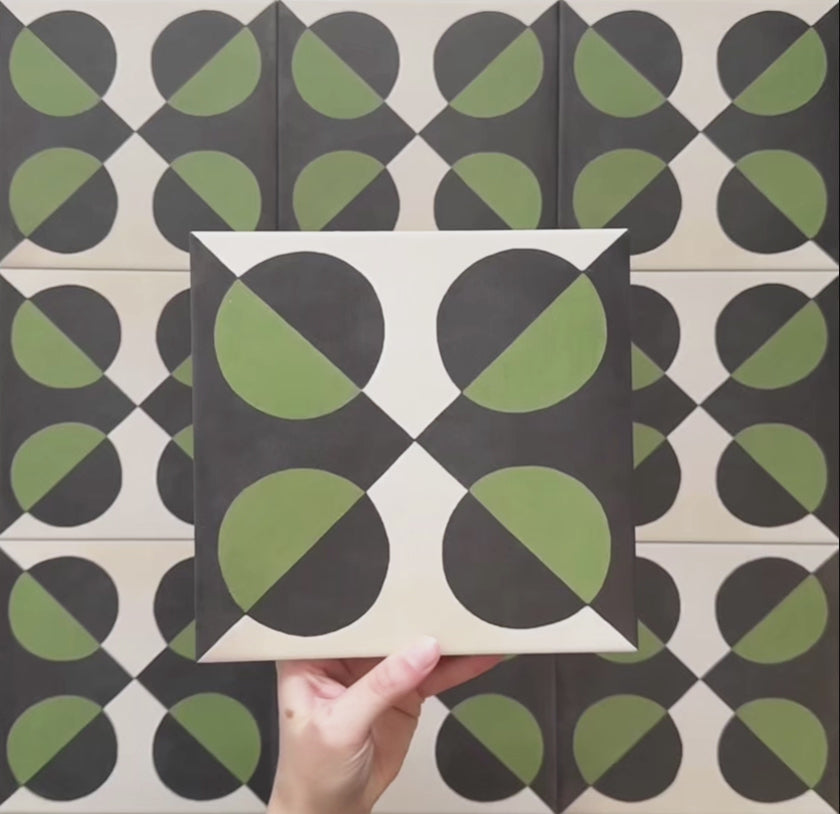 Video showcasing the Geometry Illusion Verde Noir 20x20cm geometric patterned tile, highlighting its green and black semicircle design with cream intersecting diamonds, and demonstrating how the pattern forms bold repeats when multiple tiles are laid together.