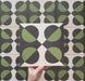 Video showcasing the Geometry Illusion Verde Noir 20x20cm geometric patterned tile, highlighting its green and black semicircle design with cream intersecting diamonds, and demonstrating how the pattern forms bold repeats when multiple tiles are laid together.