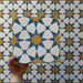 Video showcasing Agraba Sunshine 20x20cm Moroccan-style ceramic tiles, highlighting their geometric star pattern in blue, mustard yellow, and white with a smooth matt finish under natural light.