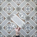 Video showcasing the Carnaby Heythrop Victorian-style 20x20cm porcelain wall and floor tiles, featuring close-up views of the taupe, terracotta, grey, and blue geometric floral pattern as the camera moves across the tiled surface.