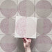 Kasuf Rose 20x20cm terrazzo-style decor tiles featuring a soft pink and neutral circular pattern with speckled terrazzo detailing, ideal for adding a playful yet elegant geometric look to contemporary interiors.