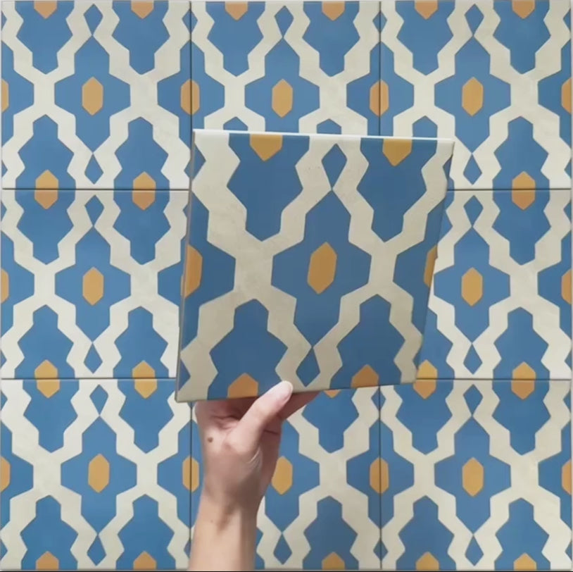 Video showcasing Cabana Zafini Mustard Azure 20x20cm Moroccan-style porcelain tiles featuring a geometric lattice pattern in azure blue and mustard yellow on a cream background, highlighting the intricate design and smooth matt finish
