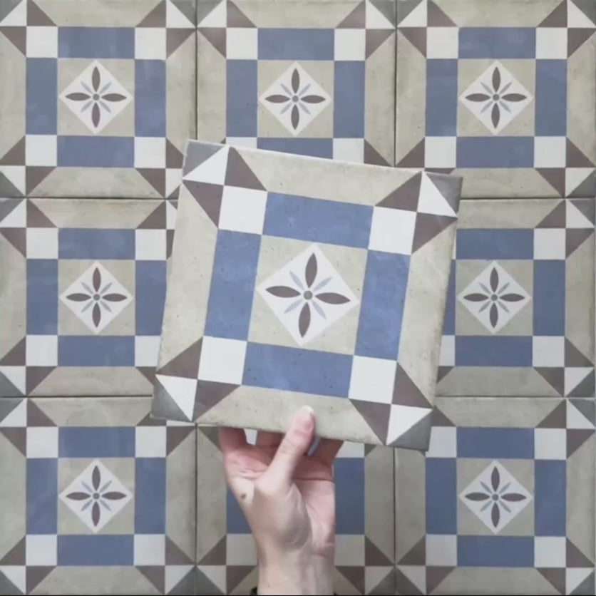 Video showcasing the Carnaby Lane Victorian-style 20x20cm porcelain wall and floor tiles, featuring close-up views of the blue and taupe geometric pattern with central floral motifs as the camera moves across the tiled surface.