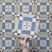 Video showcasing the Carnaby Lane Victorian-style 20x20cm porcelain wall and floor tiles, featuring close-up views of the blue and taupe geometric pattern with central floral motifs as the camera moves across the tiled surface.