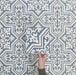 Video showcasing Europa Trondheim Blue 20x20cm Victorian Moroccan style tiles arranged together to showcase the repeating decorative pattern in blue and white tones, displayed against a textured grey background.