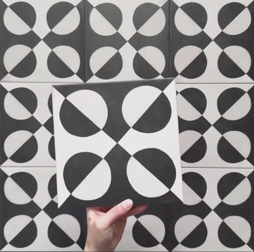 Video showcasing the Geometry Illusion Noir 20x20cm geometric patterned tile, highlighting its bold black and cream semicircle design and demonstrating how the pattern forms a striking repeat when multiple tiles are laid together.