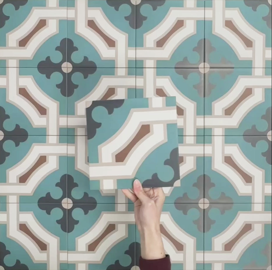 Video showcasing Europa Cologne 20x20cm Victorian Moroccan style tiles arranged together to showcase the repeating geometric pattern in teal, brown, cream and dark blue tones, displayed against a textured aqua background.