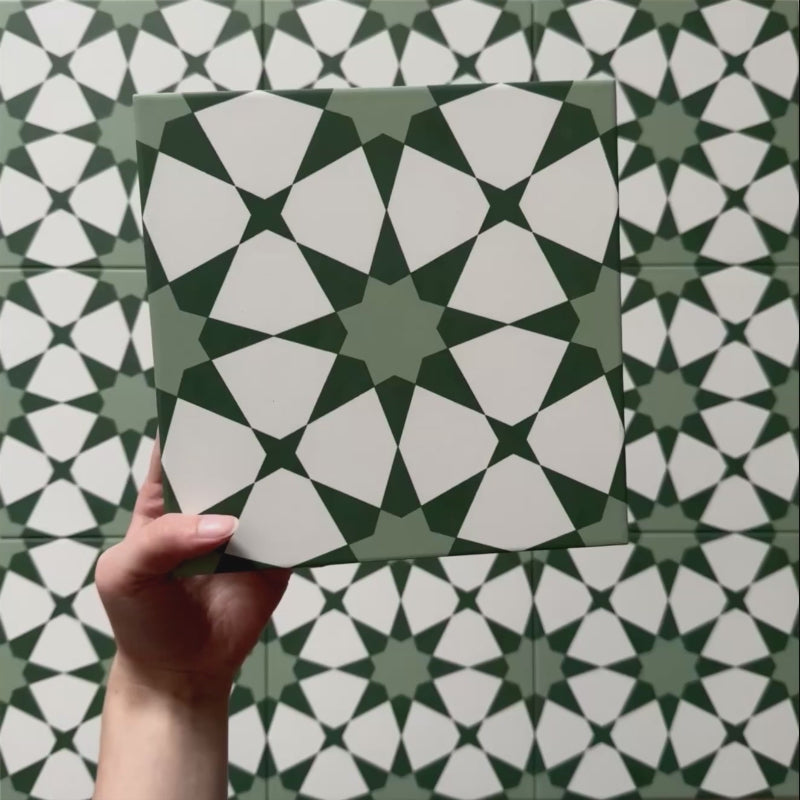 Video of Agraba Green 20x20cm Moroccan-style ceramic tile showcasing its geometric star pattern in layered green and white shades, highlighting the intricate design and smooth matt surface finish.