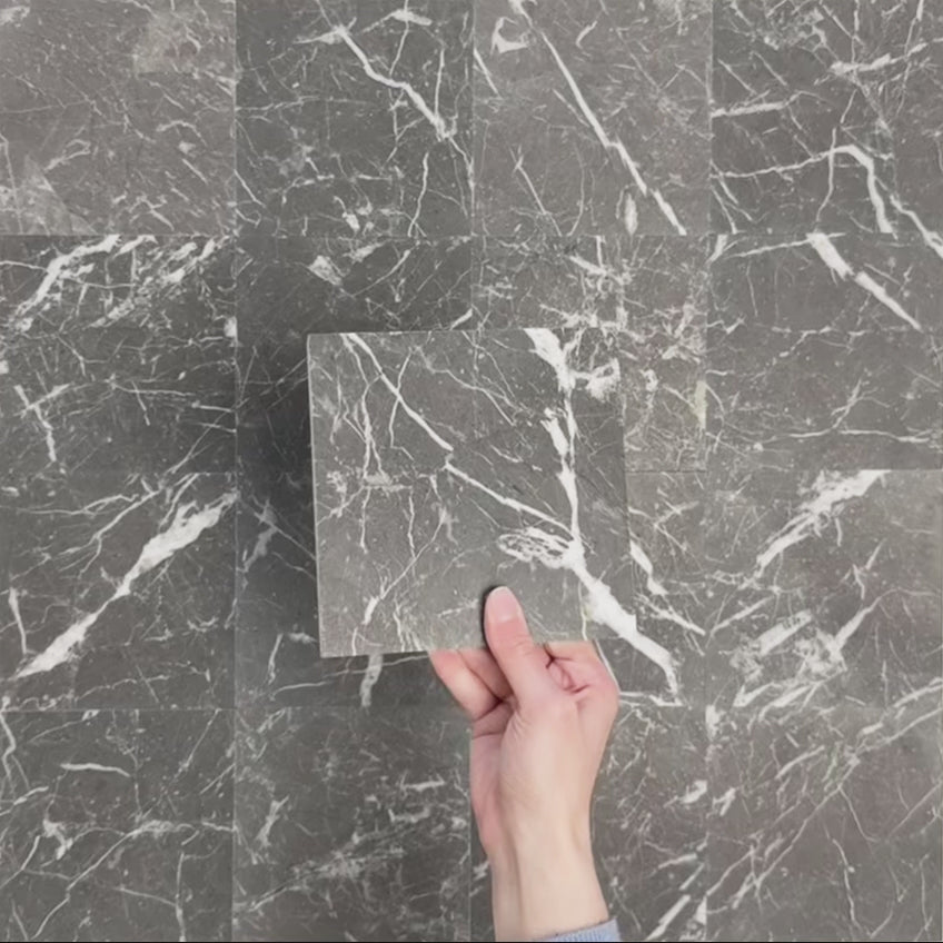 Video showcasing Fitzrovia Black 15.2x15.2cm honed natural marble tiles arranged in a square layout, showcasing deep charcoal tones, bold white veining, tonal variation, and a smooth, refined finish.
