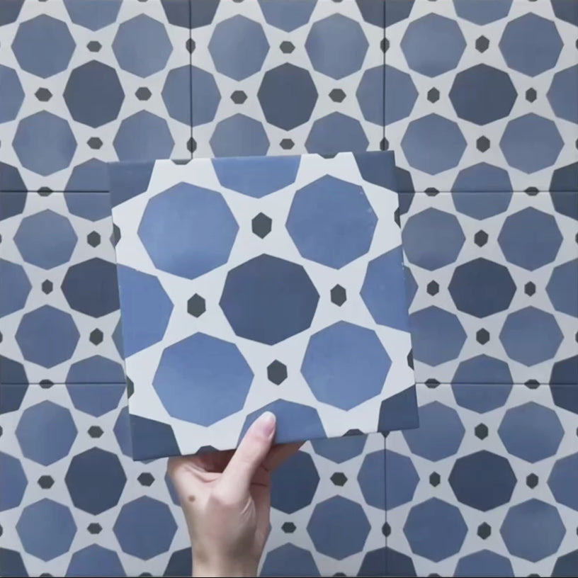 Video showcasing the Carnaby Sapphire Victorian-style 20x20cm porcelain wall and floor tiles, featuring close-up views of the bold blue geometric octagon pattern with white connecting lines and small charcoal accents as the camera moves across the tiled surface.