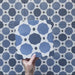 Video showcasing the Carnaby Sapphire Victorian-style 20x20cm porcelain wall and floor tiles, featuring close-up views of the bold blue geometric octagon pattern with white connecting lines and small charcoal accents as the camera moves across the tiled surface.