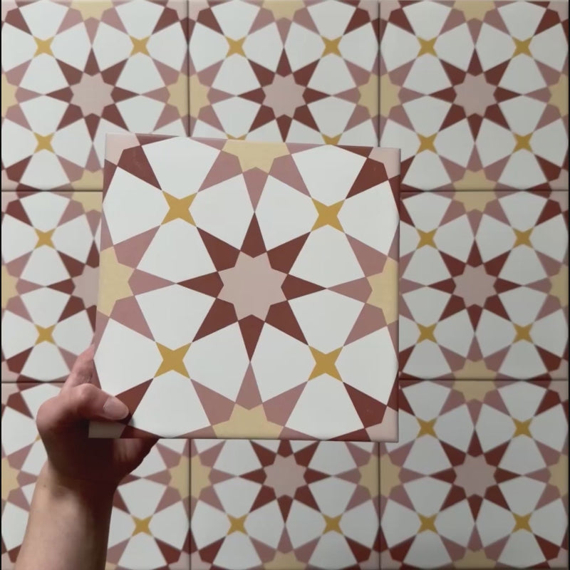 Video showcasing Agraba Springs 20x20cm Moroccan-style ceramic tiles, highlighting their geometric star pattern in terracotta, blush pink, mustard, and white tones with a smooth matt finish under natural light.