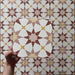 Video showcasing Agraba Springs 20x20cm Moroccan-style ceramic tiles, highlighting their geometric star pattern in terracotta, blush pink, mustard, and white tones with a smooth matt finish under natural light.