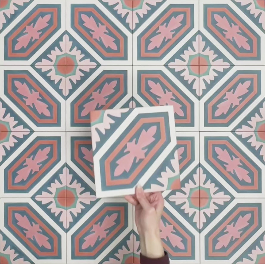Video showcasing Europa Vienna 20x20cm Victorian Moroccan style tiles arranged together to showcase the repeating geometric pattern in blue, pink and coral tones, displayed against a soft pink background.