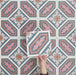 Video showcasing Europa Vienna 20x20cm Victorian Moroccan style tiles arranged together to showcase the repeating geometric pattern in blue, pink and coral tones, displayed against a soft pink background.