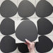 Pebble Beach Reversed Black 20x20cm patterned tiles featuring a bold black organic circular design, ideal for creating striking monochrome floors and statement walls with a contemporary geometric aesthetic.