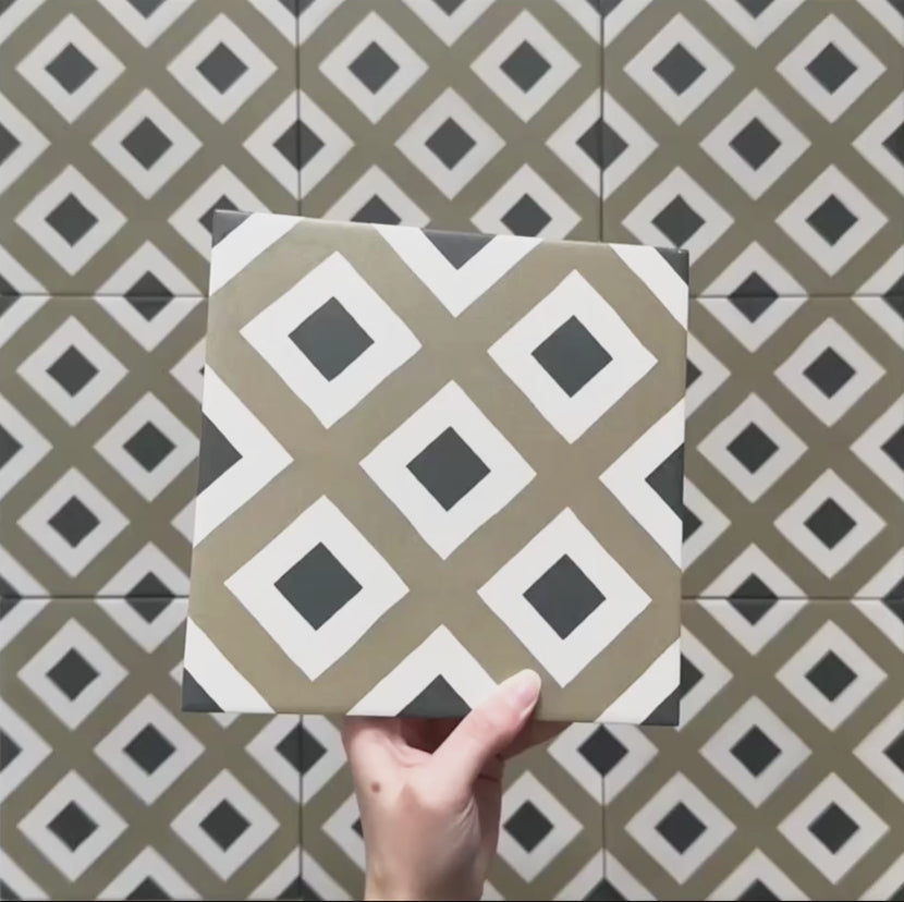 Video showcasing the Carnaby Park Road Victorian-style 20x20cm porcelain wall and floor tiles, featuring close-up views of the repeating olive, white, and black diamond geometric pattern as the camera pans across the tiled surface.