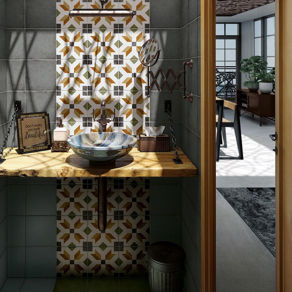 Bathroom sink area featuring Carnaby High Street Victorian-style 20x20cm porcelain wall and floor tiles, showcasing a bold geometric pattern in mustard, green, white, and charcoal tones, styled with a rustic wooden countertop, vessel basin, and dark green surrounding tiles.