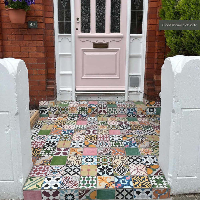 Customer doorstep featuring Fihrdos Mini Patchwork Moroccan-style 15x15cm patterned porcelain floor tiles, creating a colourful mosaic-style entrance with mixed geometric designs.